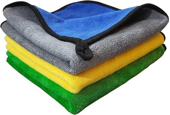 Stack of folded microfiber cleaning cloths in grey, blue, yellow, and green