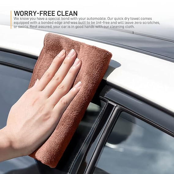 Brown microfiber cleaning cloth wiped across a car dashboard vent with hand