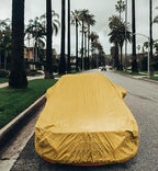 All weather car cover, yellow, full vehicle cover on street