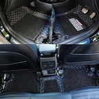 Installed custom-fit car floor mat with diamond-stitched trim and black carpet backing