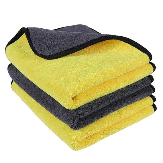 Folded microfiber cleaning cloths with yellow and dark gray sides and black border