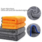 Stack of double-sided microfiber towels, orange and gray with silk-banded edging.