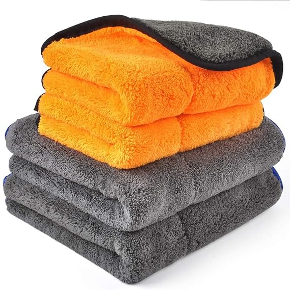 Stack of grey and orange microfiber cleaning cloths with black trim