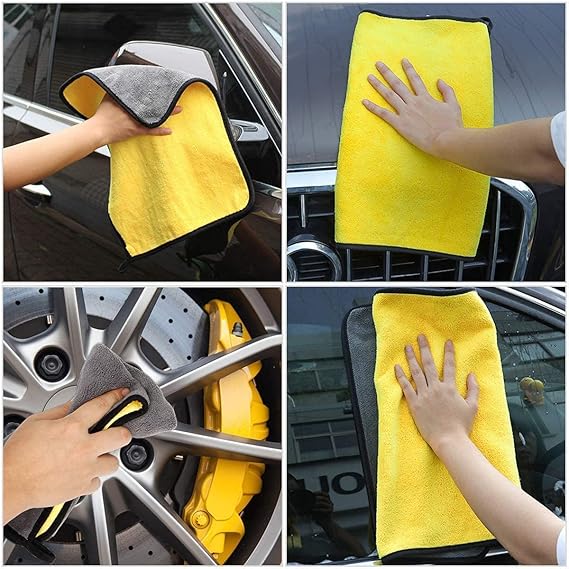 Yellow microfiber cleaning cloth held against a car surface