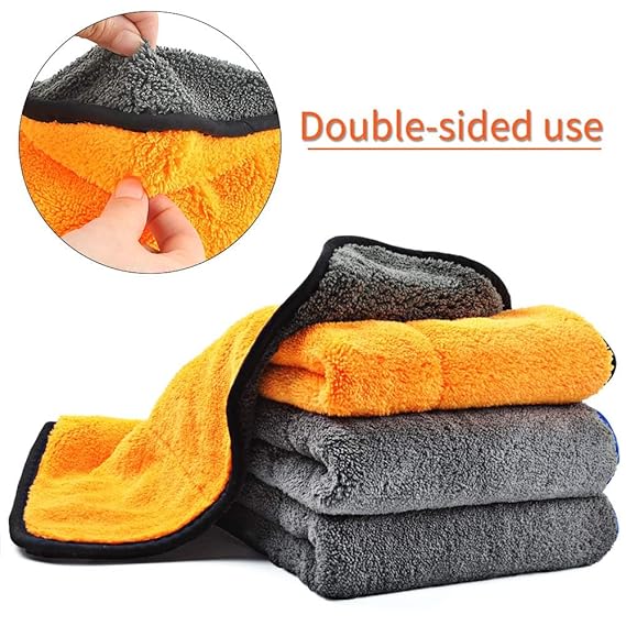 Double-sided microfiber cloth with silk-banded edge, orange and gray, folded.