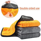 Double-sided microfiber cloth with silk-banded edge, orange and gray, folded.