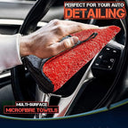 Red and dark gray double-sided microfiber detailing cloth, wiping a car interior surface.