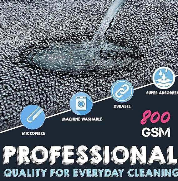 Close-up microfiber cleaning cloth, dark gray textured surface with water droplets.