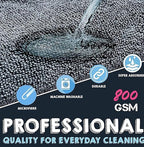 Gray microfiber cleaning cloth with looped texture and stitched edge, water droplets visible