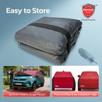 Folded all-weather car cover in dark gray storage bundle with compact rolled shape
